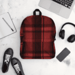 A Celtic Red Highland Plaid backpack with headphones and earphones.