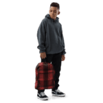A young boy wearing a Backpack in Celtic Red Highland Plaid, can hold up to a 15" Laptop, or Tablet, many pockets for more, Padded Shoulder Strapssturdy, Water Resistant.