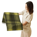 Woman holding a green and black plaid fabric.