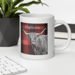 White mug with Highland cow on red plaid.