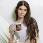 Woman holding a mug with a highland cow.