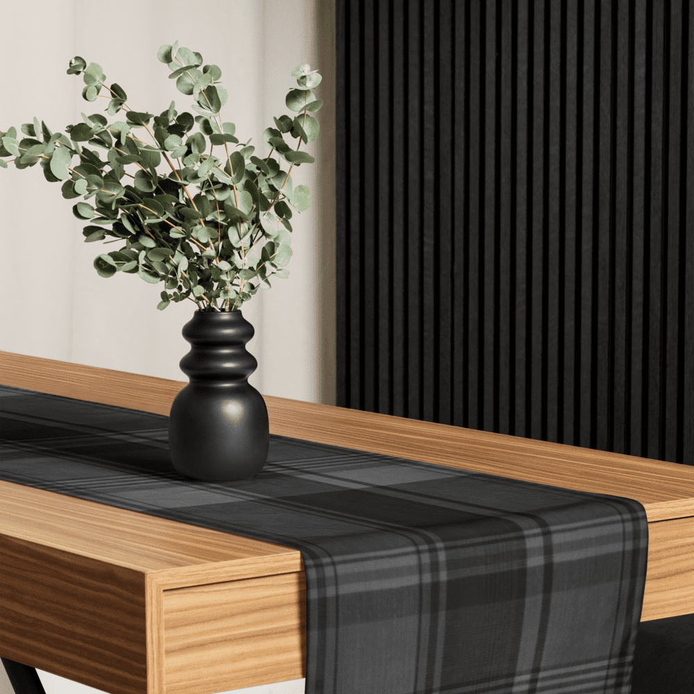 Black and gray plaid table runner with vase.