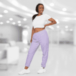 Woman wearing a white crop top and lavender pants.