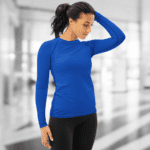 Woman in blue long-sleeve shirt and black pants.