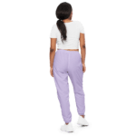 Woman in white shirt and purple sweatpants.