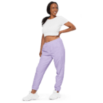 Woman in white crop top and purple pants.