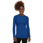 Smiling woman wearing a blue long sleeve shirt.