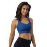 Woman in blue sports bra and black pants.