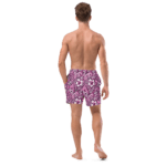 Man wearing floral print swim trunks.