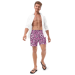 Man wearing pink floral print swim trunks.