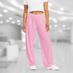 Woman wearing pink sweatpants and white sneakers.