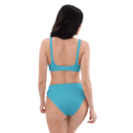 Woman in blue bikini, back view.