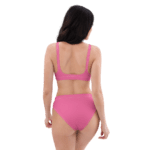 Woman in pink bikini looking away.