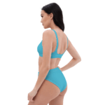 Woman in a blue bikini, back view.