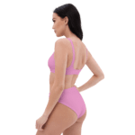 Woman in pink bikini bottoms and bra.