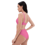 Woman in pink bikini, back view.