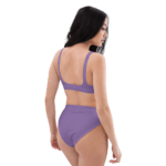 Woman in a purple bikini from behind.