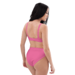 Woman in pink bikini bottoms and bra.