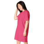 Woman smiling in a pink t-shirt dress.