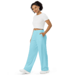 Woman in white top and light blue pants.