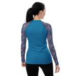 Woman in blue shirt with floral sleeves.