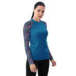 Woman wearing blue shirt with floral sleeves.