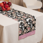 Floral table runner with pink trim.