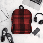 Red and black plaid backpack on white background.