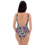 Woman in a floral swimsuit with butterfly design.