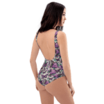 Woman wearing a floral one-piece swimsuit.