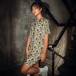 Woman in sunflower dress on stairs.