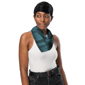 Woman wearing a plaid scarf and white tank top.