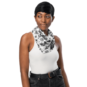 Woman wearing black and white floral scarf.