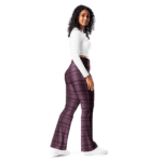 Woman wearing white shirt and plaid pants.