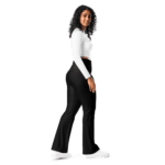 Woman wearing black flared pants and white shirt.