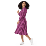 Woman in pink plaid dress and white sneakers.