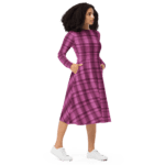 Woman in pink plaid dress with white shoes.