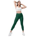 Woman in green leggings and white top.