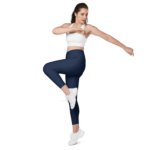 Woman in navy leggings and white top stretching.