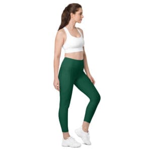 Woman in green leggings and white top.