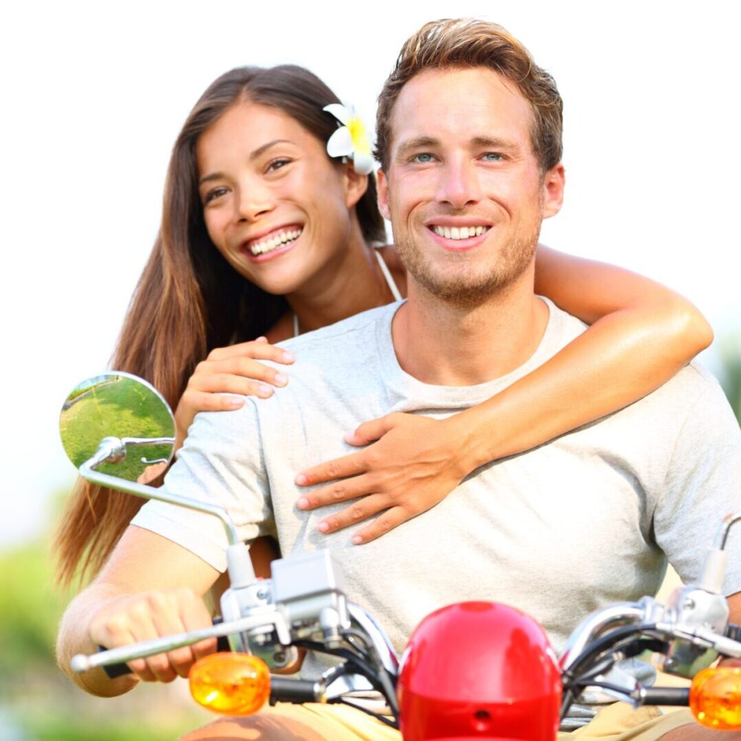 17425293 - happy young couple in love on scooter driving together  multiracial couple having fun in the free outdoor  smiling caucasian man and asian woman
