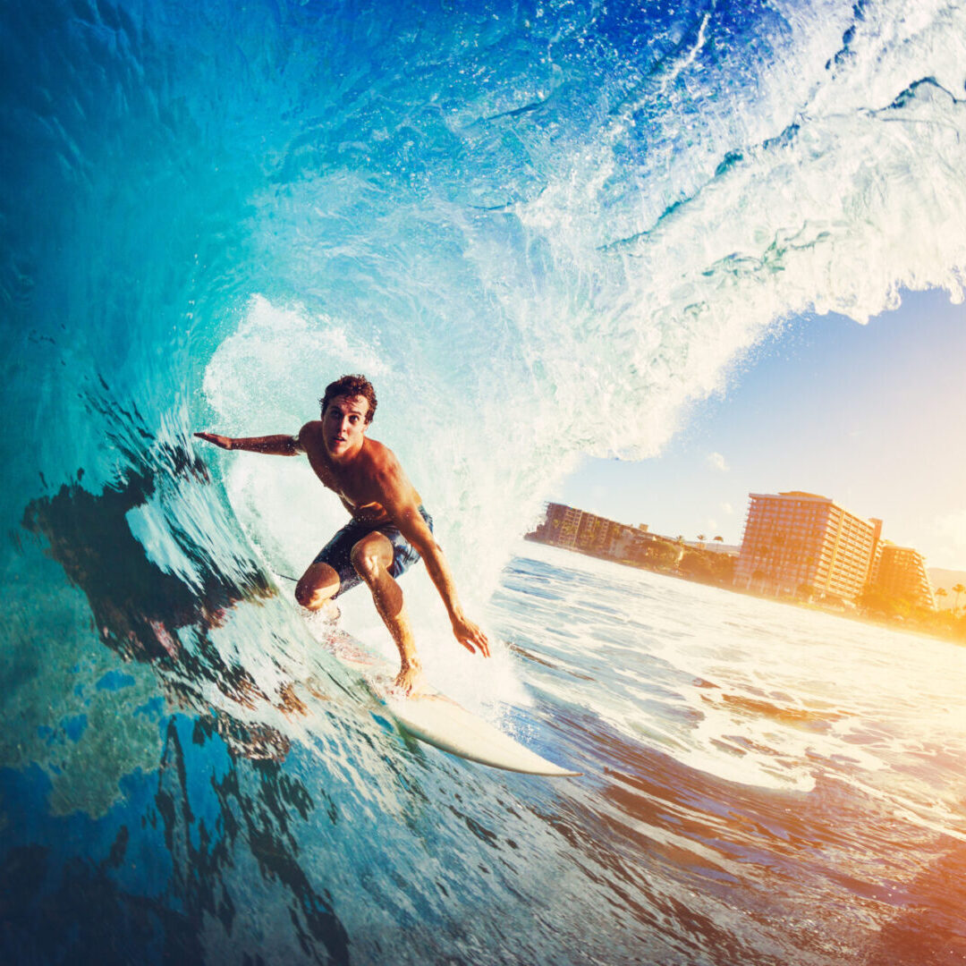 Surfer on Blue Ocean Wave Getting Barreled at Sunrise